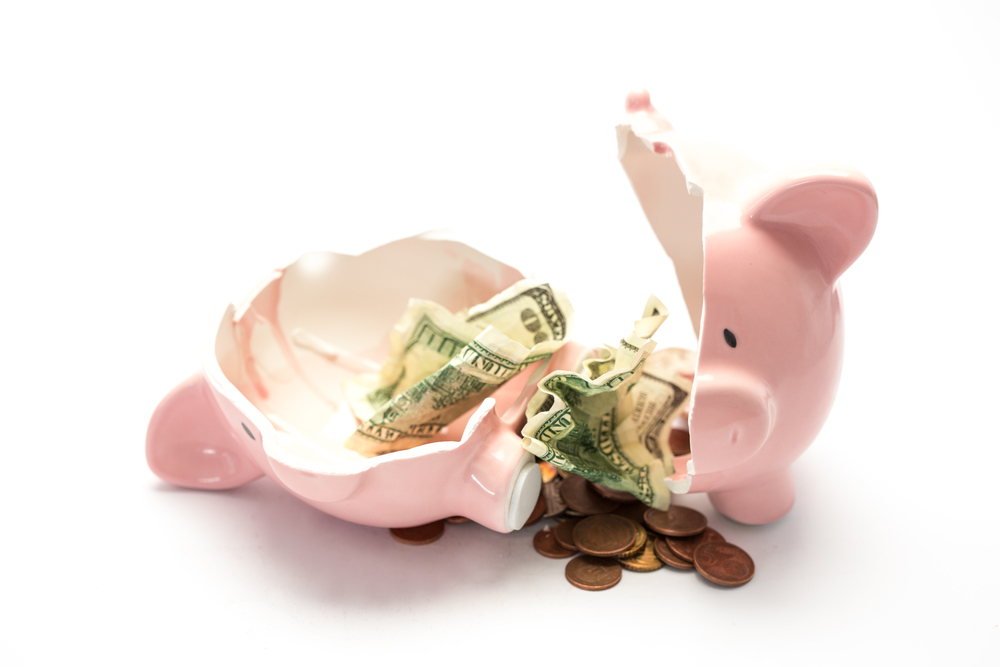 Piggy bank broken with money inside on white background-1